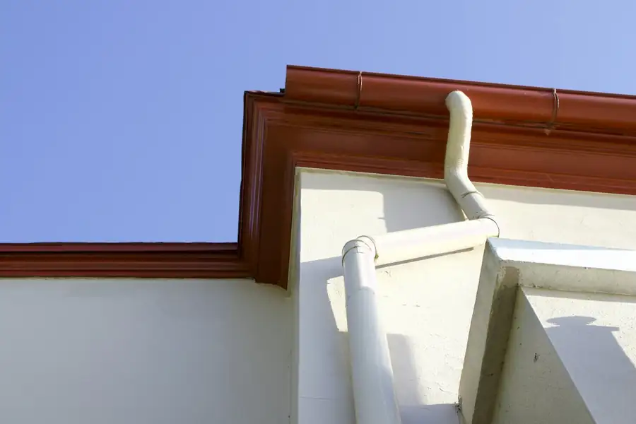 Close-up of a gutter corner and downspout on a home
